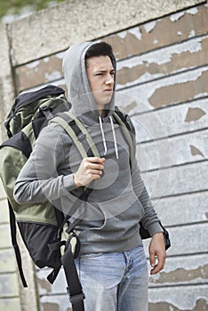 Homeless Teenage Boy On Street With Rucksack