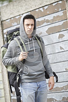 Homeless Teenage Boy On Street With Rucksack