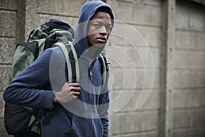 Homeless Teenage Boy On Streets With Rucksack