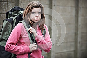 Homeless Teenage Girl On Street With Rucksack