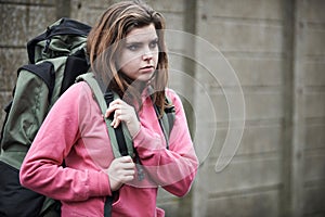 Homeless Teenage Girl On Streets With Rucksack photo