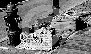 Homeless Veteran sign and belongings on Boston city street