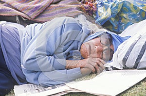 Homeless woman sleeping in a park, Los Angeles, California