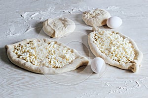 Homemade Ajarian Khachapuri with Suluguni Cheese. Stage of work. Preparation for baking.