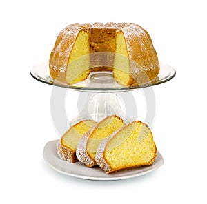 Homemade Alsatian sour cream coffee cake on glass cake plate with stand isolated on white background with shadow reflection.