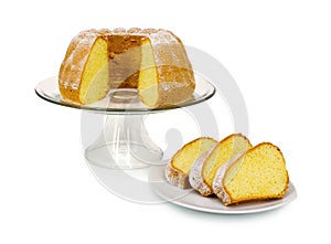 Homemade Alsatian sour cream coffee cake on glass cake plate with stand isolated on white background with shadow reflection.