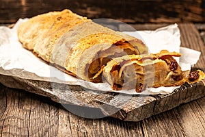 Homemade apfelstrudel, Apple strudel with raisins and mint on light background. view from above, Food recipe background, austrian