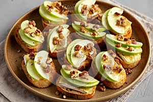 Homemade Apple Brie Crostinis on a Plate, side view. Close-up