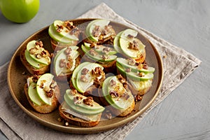 Homemade Apple Brie Crostinis on a Plate, side view. Close-up