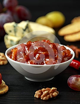 Homemade apple and chilli chutney with cheese, snack, nuts, fruits