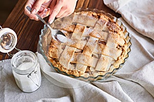 Homemade apple pie on the brown wooden table. Apple tart with lattice top overhead view. Rustic style