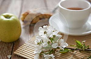 Homemade apple pie with cinnamon and cup of tea