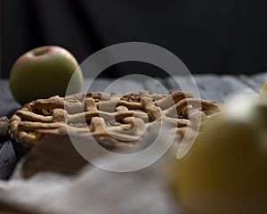 Homemade Apple pie with cinnamon on an old textured wooden background