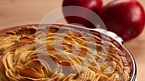 Homemade apple pie rotating, rack focus from red apples to the pie