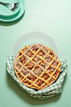 Homemade apple tart on a green table. Delicious apple pie with a lattice crust