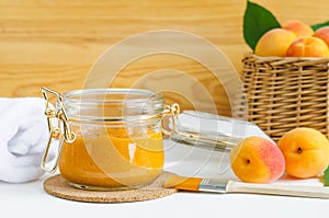 Homemade apricot face mask in a glass jar and make-up brush. Natural beauty treatment and spa