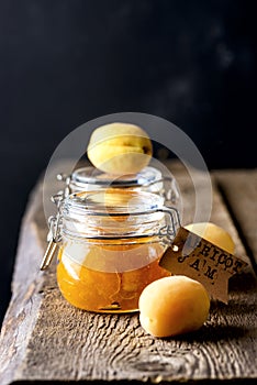 Homemade Apricot Jam in Jars and Fresh Fruits Apricot Old Wooden Background Dark Photo Vertical