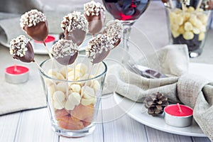 Homemade apricot and prunes lollipops with chocolate and macadamia nuts