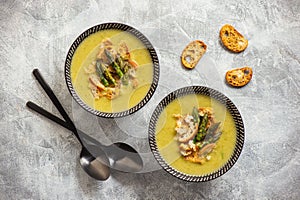 Homemade asparagus cream soup with croutons.