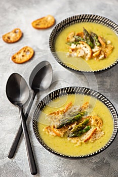 Homemade asparagus cream soup with croutons.