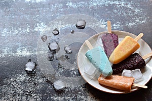 Homemade assorted flavors and colors of frozen yogurt or icecream popsicles from fruits. Summer ice dessert. Healthy food. Copy s