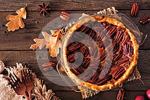 Homemade autumn pecan pie, top view table scene over rustic wood