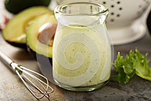 Homemade avocado ranch dressing in a small jar