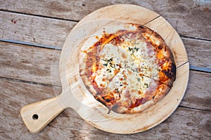 Homemade bacon cheese pizza on wood background