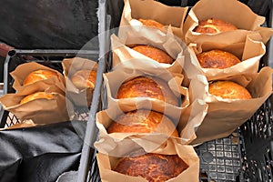 Homemade baked bread in paper packaging, bakery products of private businessmen