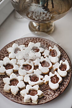 Homemade baked cookies with chocolate on a plate on white windowsill