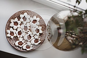 Homemade baked cookies with chocolate on a plate on white windowsill