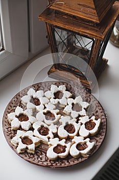 Homemade baked cookies with chocolate on a plate on white windowsill