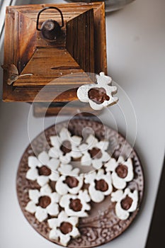 Homemade baked cookies with chocolate on a plate on white windowsill