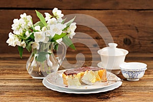 Homemade baked pudding with chololate icing, jasmine flowers in