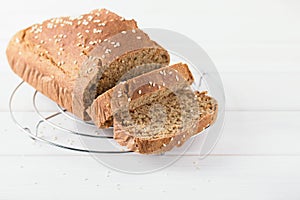 Homemade baked spelled bread on a wooden background.