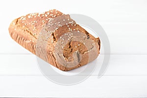 Homemade baked spelled bread on a wooden background.