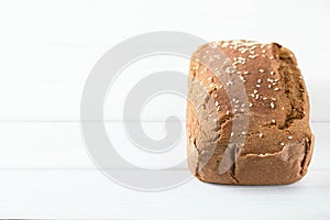 Homemade baked spelled bread on a wooden background.