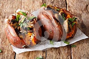 Homemade baked sweet potato stuffed with mushrooms, greens and c
