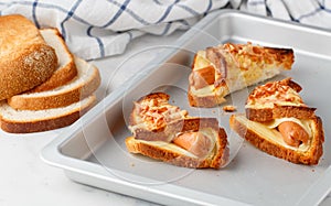 Homemade baked toast bread sandwiches with cheese and sausages