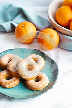 Homemade baked whole wheat vegan donuts with orange glaze