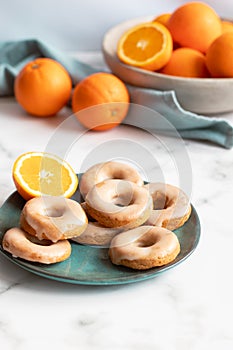 Homemade baked whole wheat vegan donuts with orange glaze