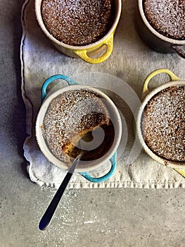 Homemade baking: gluten-free pumpkin custards in ramekins with spoon