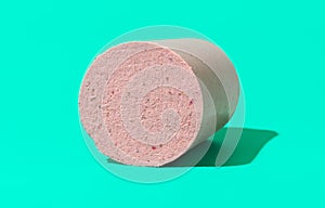 Homemade baloney isolated on a green background