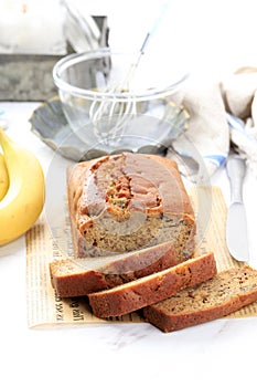 Homemade Banana Loaf Cake Bread Sliced on a Table Close Up. Vertical, White Rustic Style