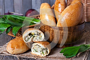 Homemade basket of Russian pastries (pirogi) filled with eggs and green onion