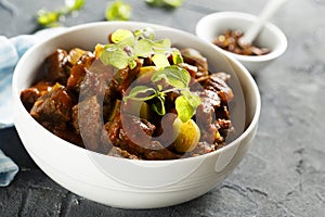 Homemade beef goulash with pickled cucumber