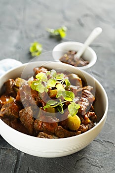 Homemade beef goulash with pickled cucumber