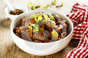 Homemade beef goulash with pickled cucumber