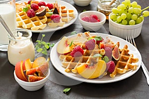 Homemade Belgian waffles with peach, raspberry, fig and honey