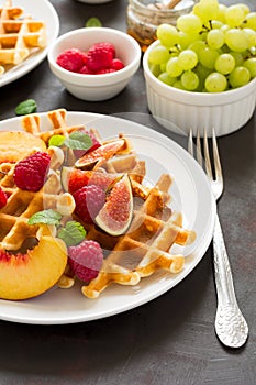 Homemade Belgian waffles with peach, raspberry, fig and honey